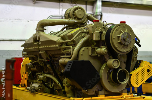 Large diesel engine with a huge turbine in the warehouse of finished products factory for the production of large mining trucks