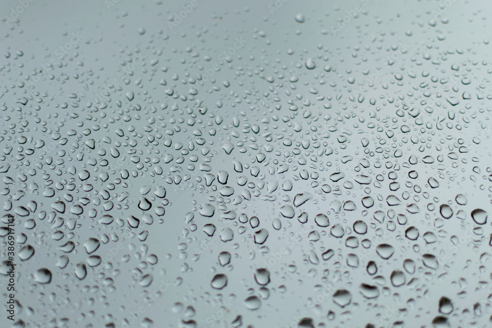 rain drops on a silver window during a thunder storm rain drops on a silver window during a thunder storm
