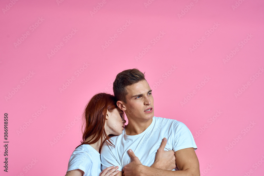 enamored man and woman hugging each other on a pink background cropped with Copy Space family portrait enamored man and woman hugging each other on a pink background cropped with Copy Space family portrait