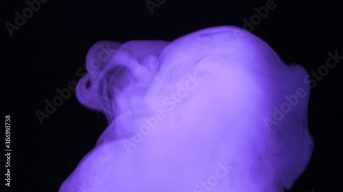 Purple smoke on a black background. Space fog. Slow motion. The footage, the texture of the smoke. Equalizer, video effect. Research, biochemistry. Alchemy. Meditation, reflection, inspiration. Aura