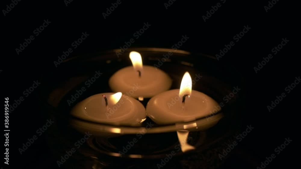 Blowing the floating candles in a glass in super slow motion then room is getting totally dark Blowing the floating candles in a glass in super slow motion then room is getting totally dark