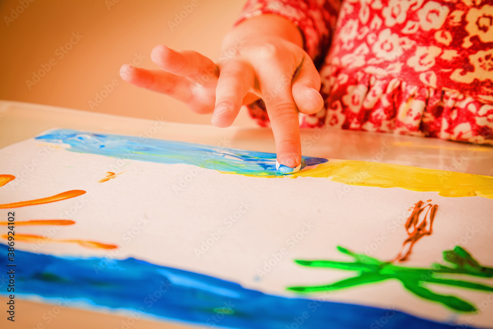 Child girl painting sea beach, home, palms and sun as symbol of dreams about summer holiday. Child girl painting sea beach, home, palms and sun as symbol of dreams about summer holiday.