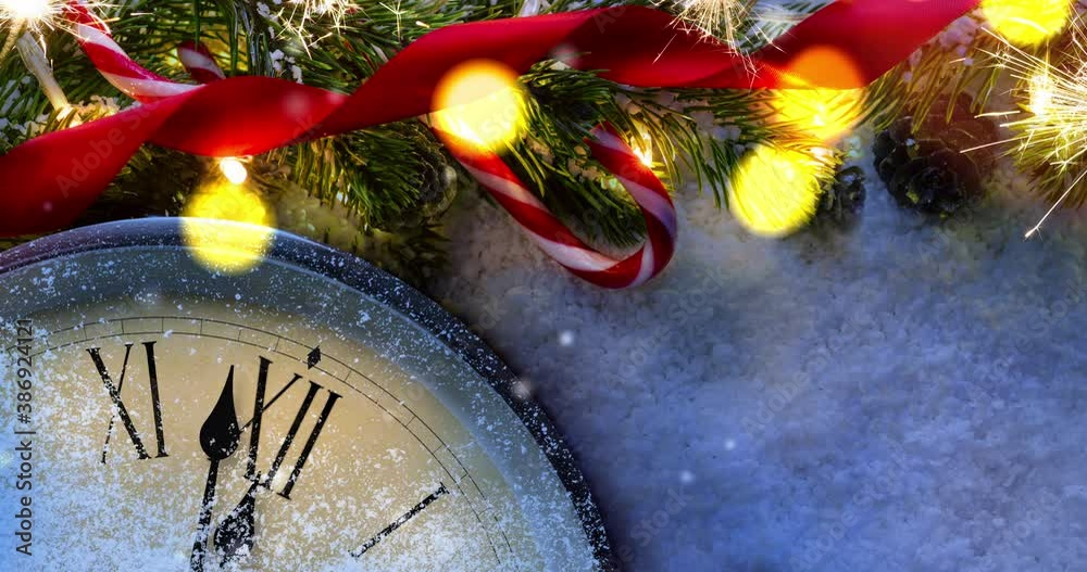 Countdown to midnight. Retro clock counting last moments before Christmas or New Year 2021 next to decorated fir tree. View from above with falling snow. Seamless loop 4k animation