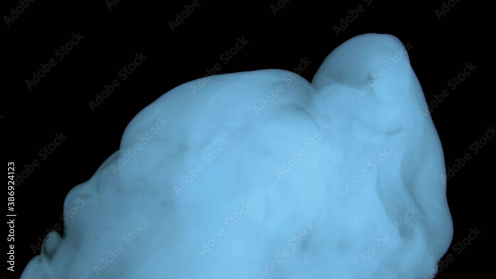 Abstract blue steam smoke on a black background.A cloud of chemical smoke.Glossy rolling poisonous gas cloud of reagent in chemistry.Toxins and toxic substances in motion.Boiling is the bubbling of a Abstract blue steam smoke on a black background.A cloud of chemical smoke.Glossy rolling poisonous gas cloud of reagent in chemistry.Toxins and toxic substances in motion.Boiling is the bubbling of a