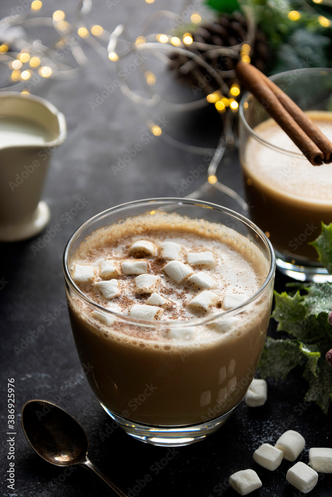 Coffee cup with milk foam and marshmellows, Christmas lights and decorations background. Copy space. Coffee cup with milk foam and marshmellows, Christmas lights and decorations background. Copy space.
