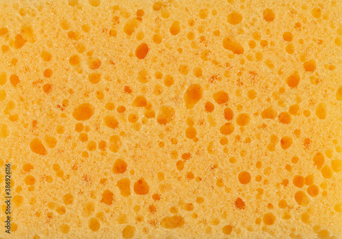 Surface of yellow sponge textured background close-up
