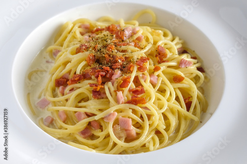 Spaghetti carbonara with bacon on white dish