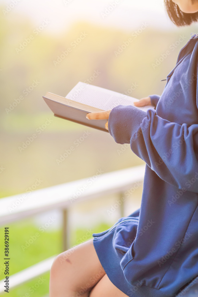 Blur image , A young woman is reading and learning the teachings of God from the Bible that she holds in her hand, with faith and faith in God making her determined to learn all of His teachings.