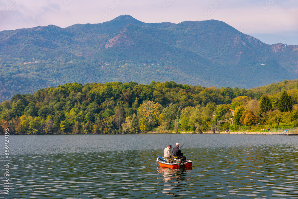 Avigliana, Italy. October 10th, 2020. View of Lake Avigliana with boats and anglers on an autumn day in October.