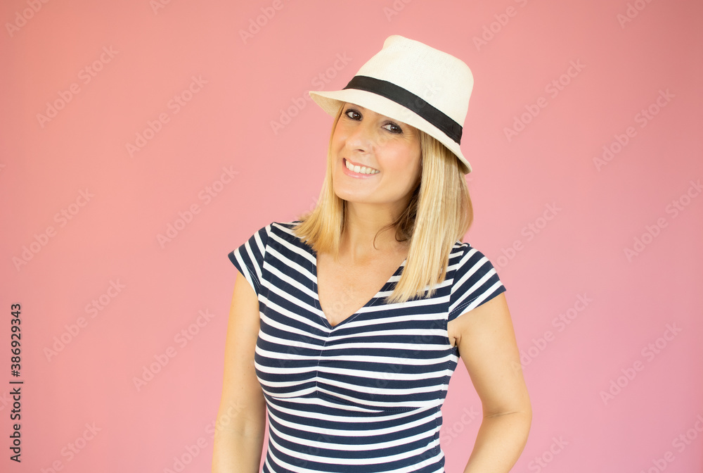 Beautiful woman with straw hat smiling and happy over pink background. Beautiful woman with straw hat smiling and happy over pink background.