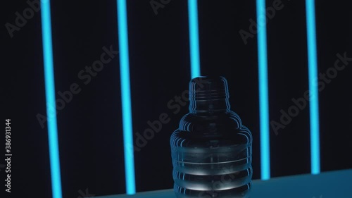 Cocktail shaker on a glass bar counter. Flashing neon light tubes in the background. Close-up. Motion control system.