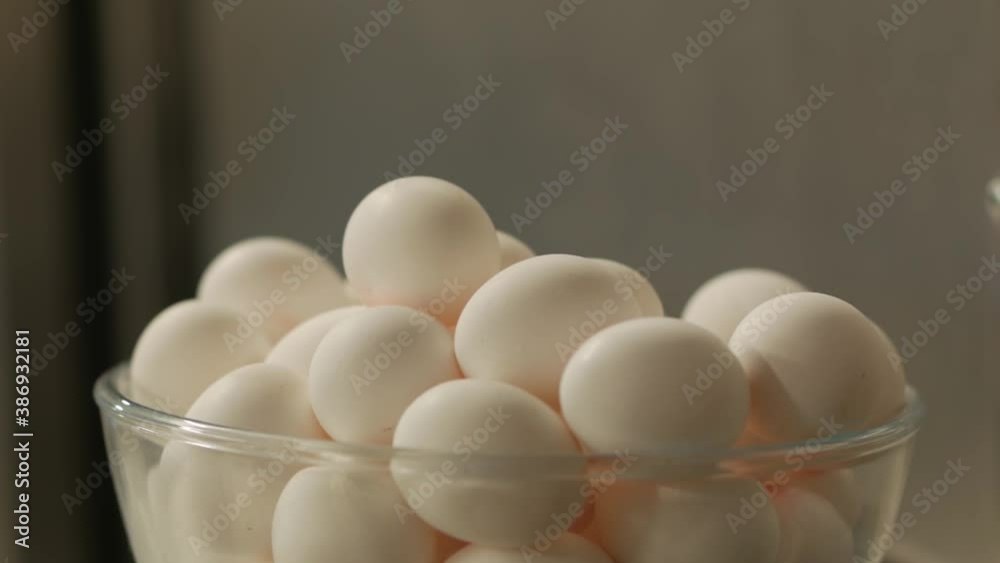 Raw white chicken eggs closeup handheld Raw white chicken eggs closeup handheld