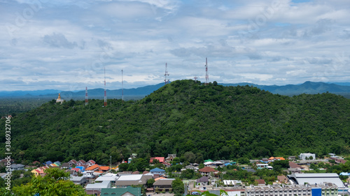 Mountain view with signal towers of various communications. Which is surrounded by residential houses of the city people in Thailand
