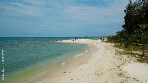 View of the beach and blue sky  white sand and tourists.