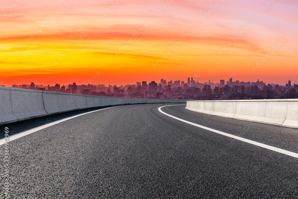 Fototapeta premium Empty asphalt road and city skyline with buildings in Hangzhou at sunrise.