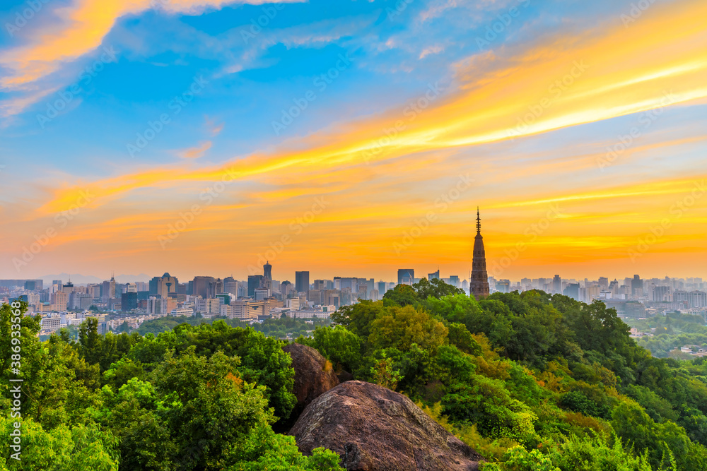 Fototapeta premium Ancient Baochu Pagoda.Chinese traditional architecture and modern city skyline in Hangzhou at sunrise,China.