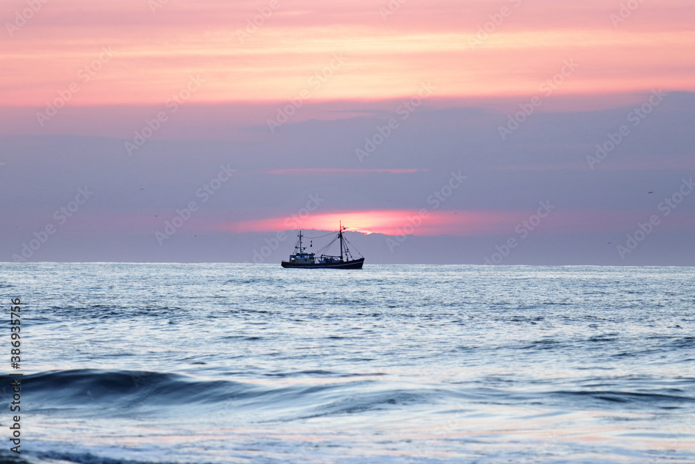 Trawler at sunset near the Dutch coast