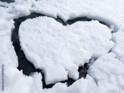 Snow funny background in the shape of a heart.
