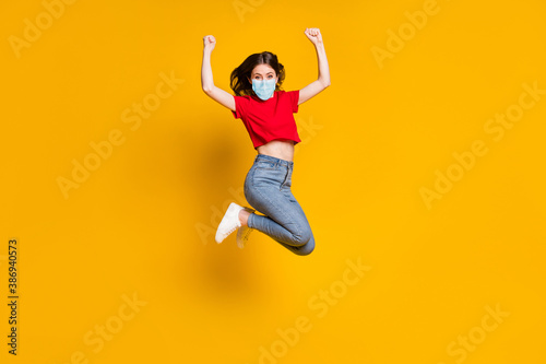 Full length photo of ecstatic girl jump win raise fists wear mask isolated over bright shine color background