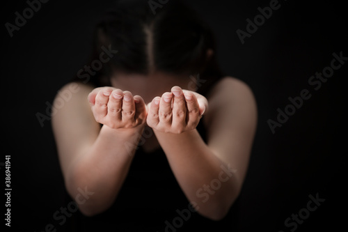 Woman's hand praying and worship to GOD Using hands to pray in religious beliefs and worship christian in the church or in general locations in vintage color tone or copy space.