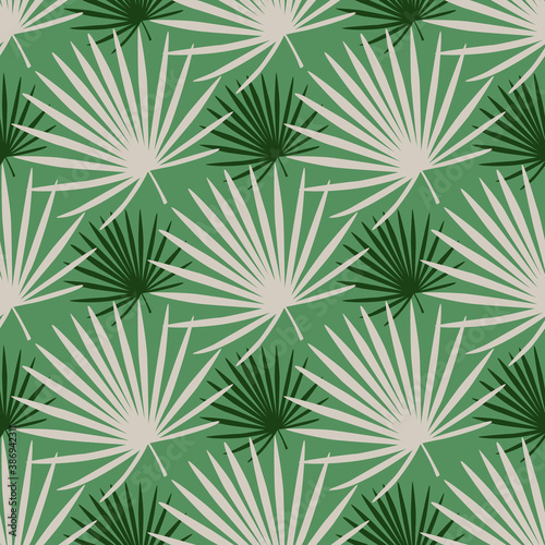 Nature fan palm branches silhouettes seamless doodle pattern. Pastel tones colored foliage on green background.