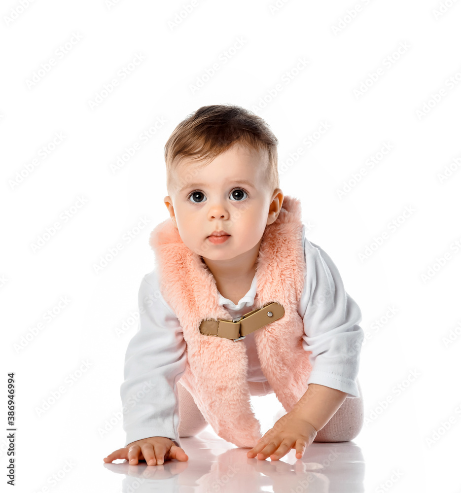 Little baby girl in warm clothes crawling on floor Little baby girl in warm clothes crawling on floor