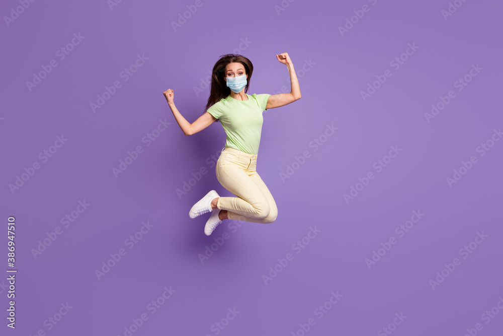 Full length view of girl jumping having fun wear mask isolated bright vivid shine vibrant lilac violet color background