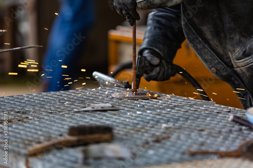 Details of welding activities - a welder is welding steel components