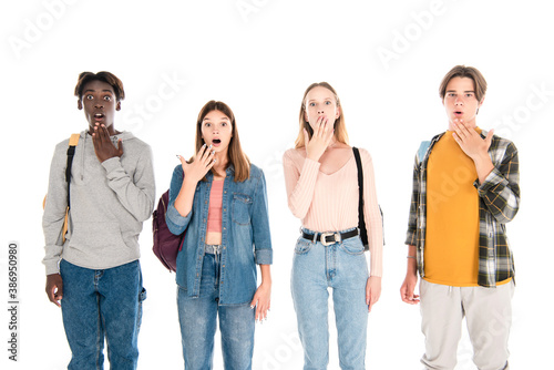 Surprised multiethnic teenagers looking at camera isolated on white