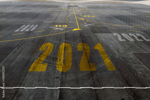 Alphabet 2021 on the airport runway floor, concept for New Year's Day.