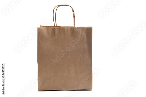 Layout of a shopping bag made of Kraft paper with handles on an isolated white background.