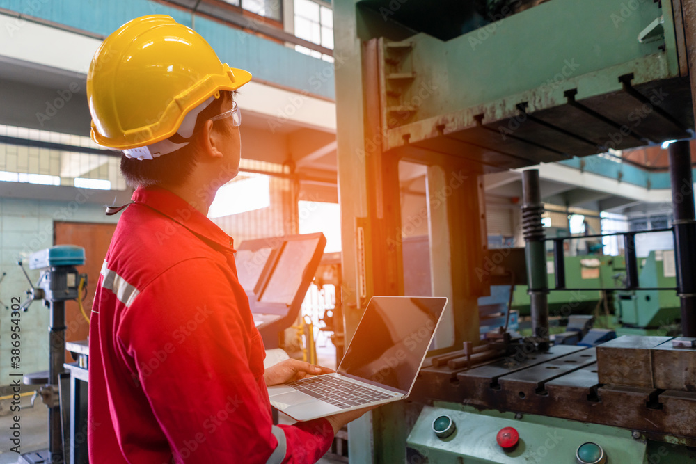 Asian man foreman working with NC Lathe machinery with safety uniform concept smart manufacturing industry technology and service. Asian man foreman working with NC Lathe machinery with safety uniform concept smart manufacturing industry technology and service.