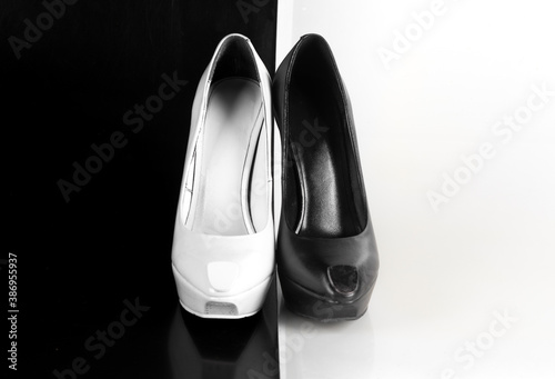 white and black high-heeled shoes on an abstract white and black background