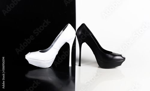 white and black high-heeled shoes on an abstract white and black background