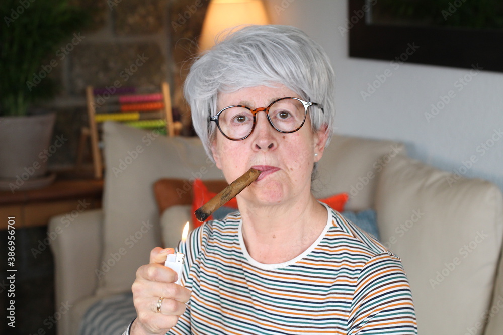 Senior woman smoking a cigar Senior woman smoking a cigar