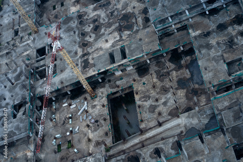 Top view of the construction site of a large building after rain. Piles are driven in and the lower floors are built. © Kate