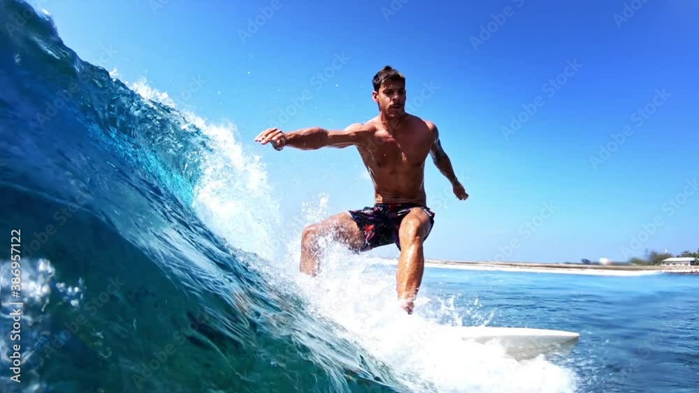 Young male surfer rides the ocean wave in Maldives Young male surfer rides the ocean wave in Maldives