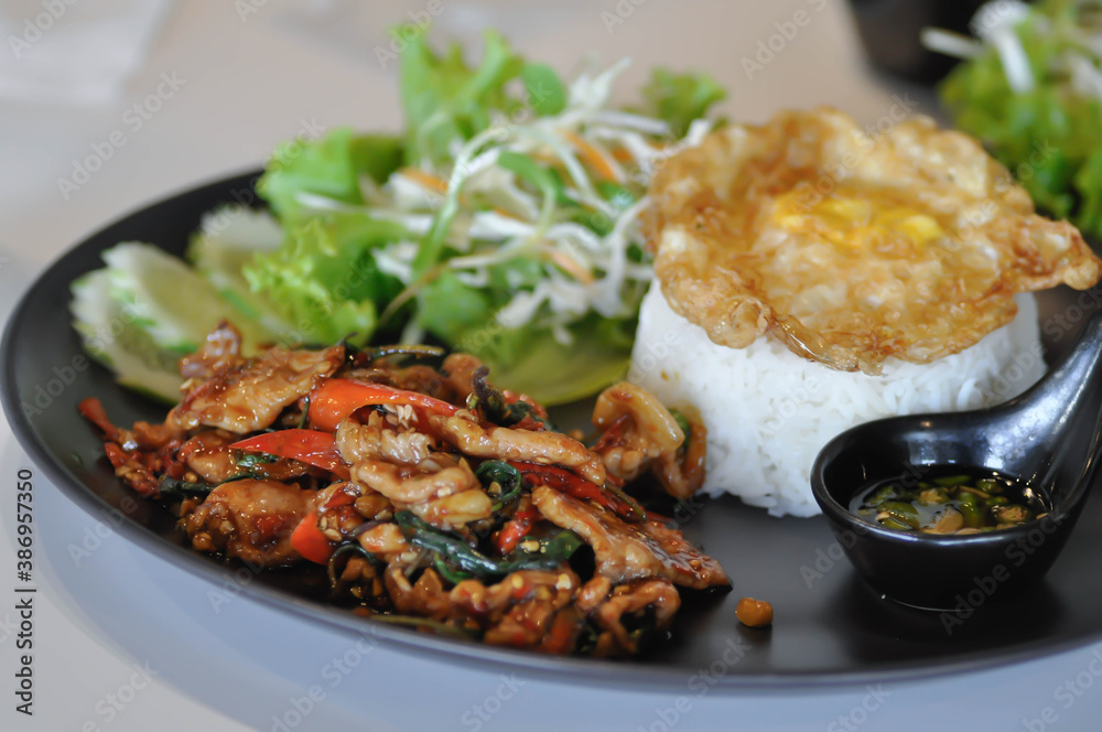 stir fried pork with holy basil , rice and fried egg stir fried pork with holy basil , rice and fried egg