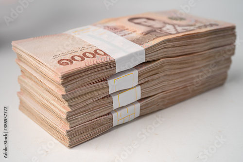 Valokuvatapetti Stack of Thai baht banknotes on wooden background, business saving finance investment concept