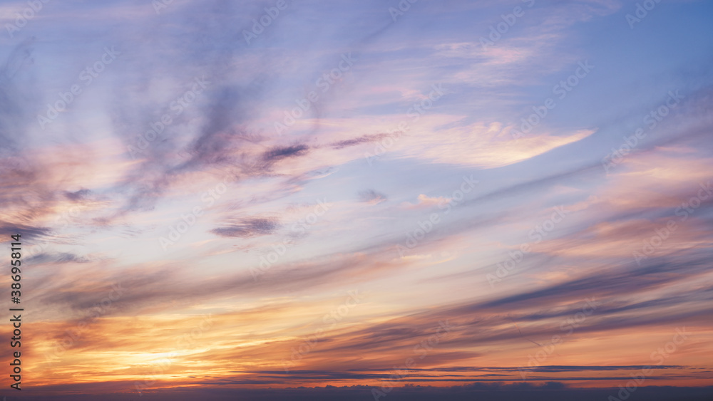 Sunset in the cloudy pastel colored sky