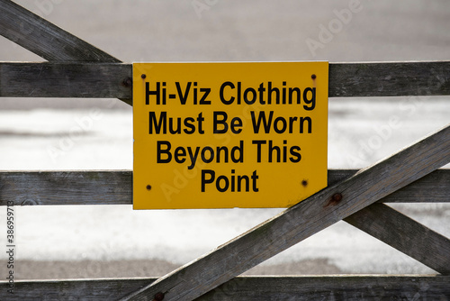 UK. 2020. High Visability clothing to be worn beyond this point sign on a farm gate. photo