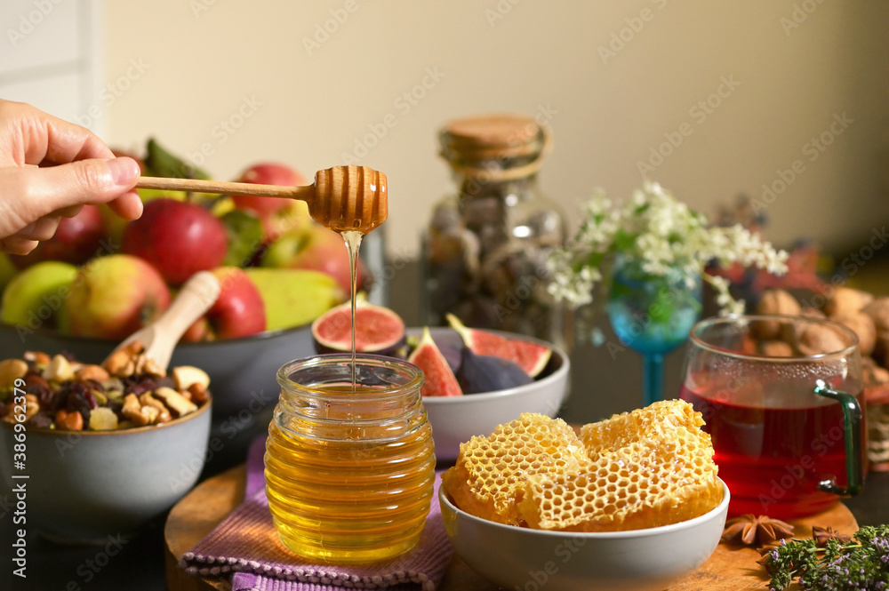 Honey, Honeycomb, Tea, Dried Fruits on Autumn Table