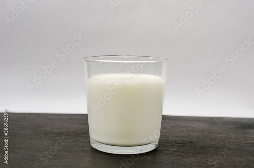 glass of milk on a black wooden table.