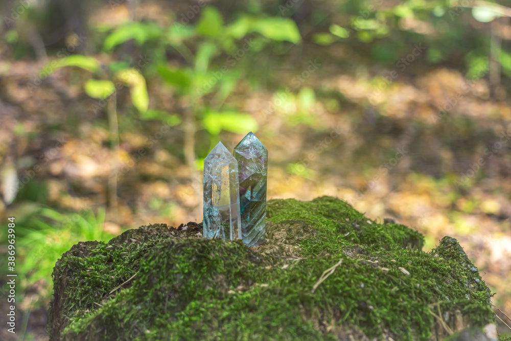 Gemstones fluorite, quartz crystal and various stones. Magic rock for mystic ritual, witchcraft Wiccan and spiritual practice on stump in forest. Meditation reiki, spiritual healing consept