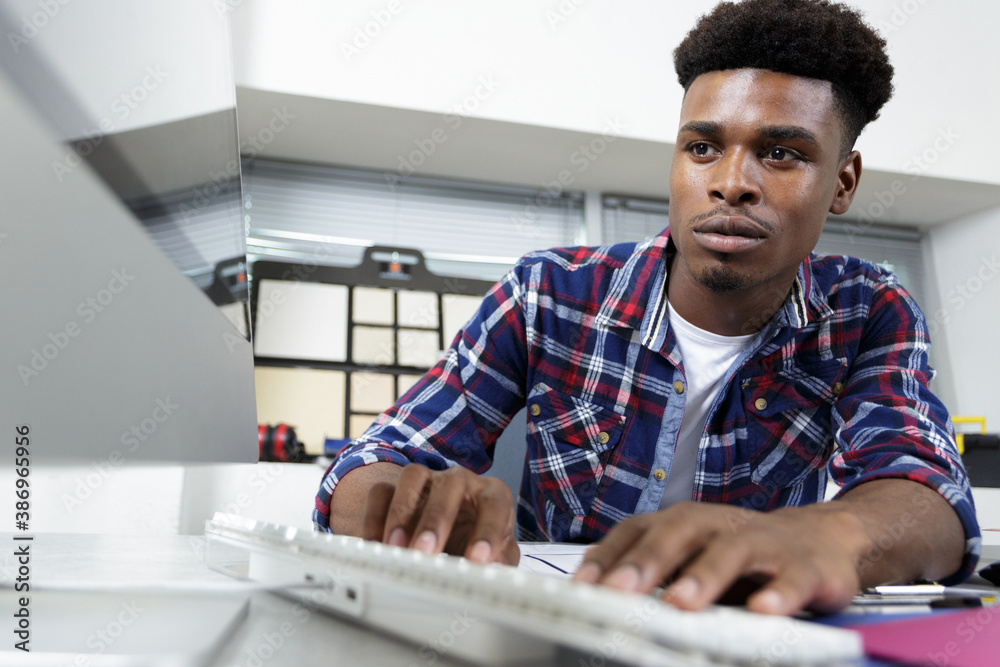 man typing on computer keyboard in office man typing on computer keyboard in office