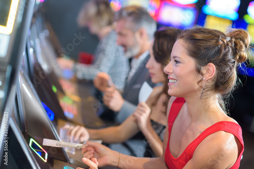 Tela adults playing arcade machines in a casino