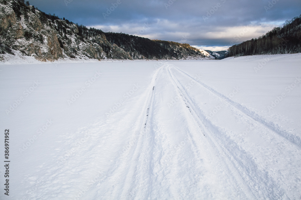 tire tracks in the snow, winter road, empty road in winter goes far to the horizon, covered with snow path, winter landscape tire tracks in the snow, winter road, empty road in winter goes far to the horizon, covered with snow path, winter landscape