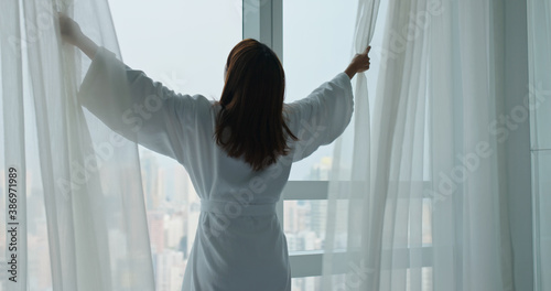 Woman open curtain at morning Free Download Woman open curtain at morning - GFXLoad