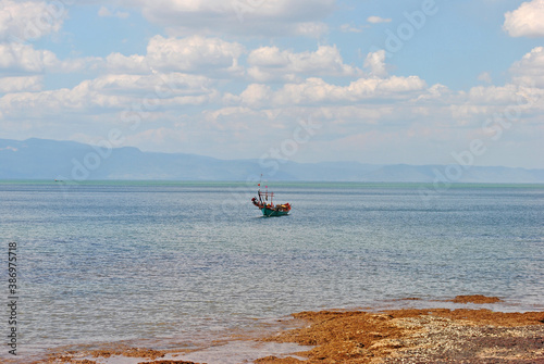 Asian fishing boat in a bay in shallow water off the coast of Cambodia