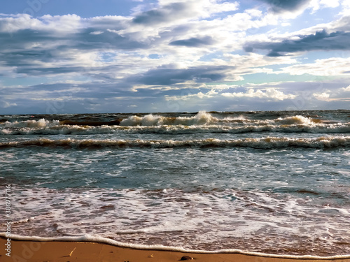 Autumn storm on the Baltic Sea. Waves run down the sandy beach